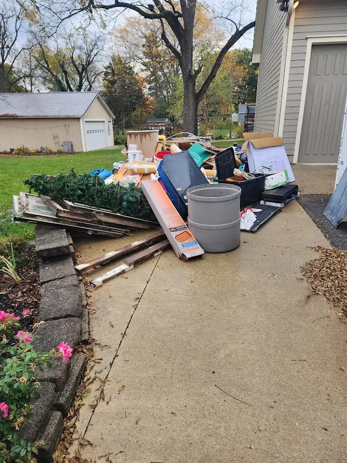 Dumpster being loaded with debris for 3 Yard Dumpster Rental in Grand Blanc